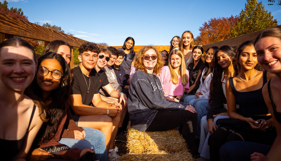 a group of students on the hayride around campus during CAB's Octoberfest event