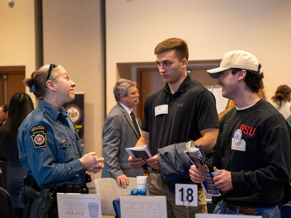 students speaking with police officer