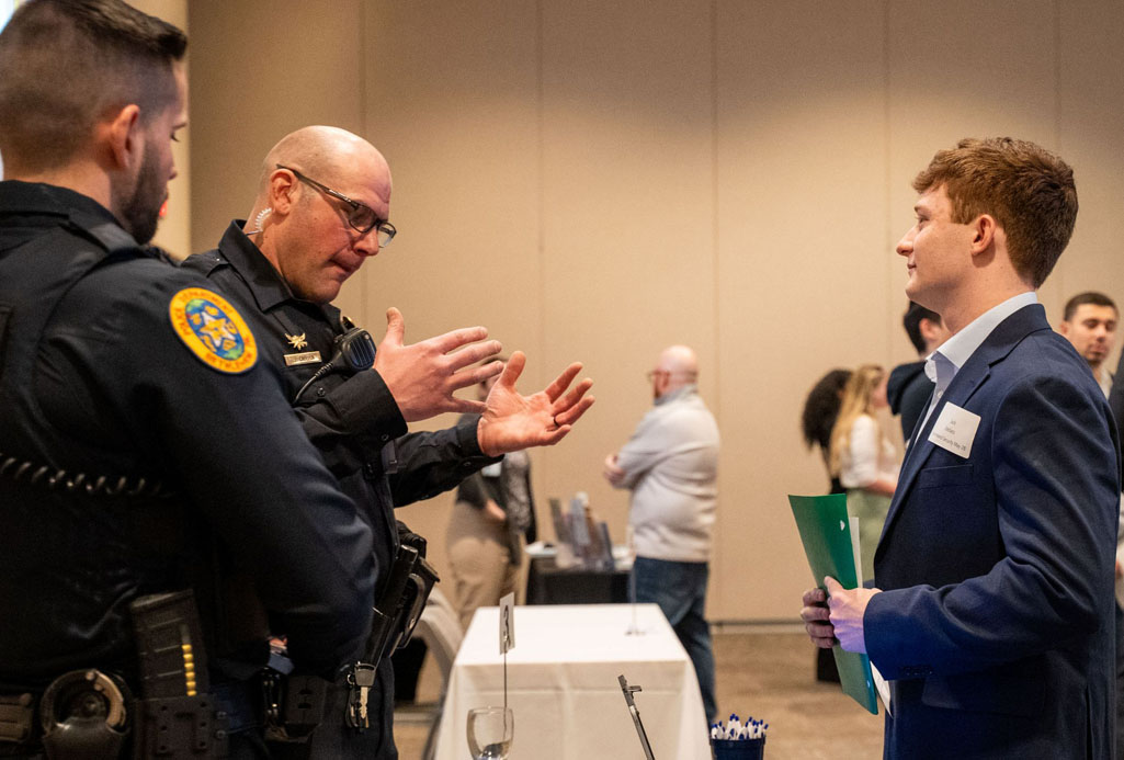 students talking with police officer