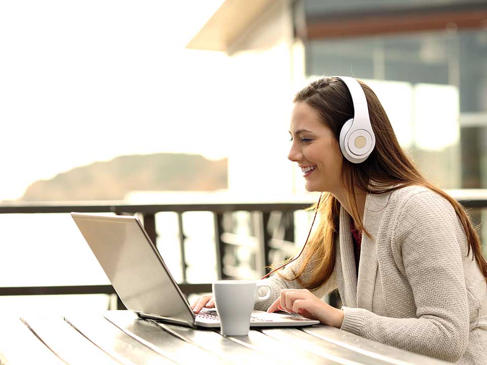 woman taking class on laptop outdoors