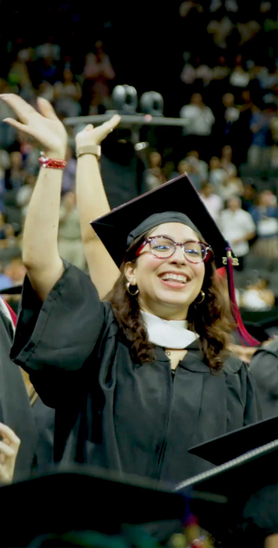 students waving during commencement ceremony
