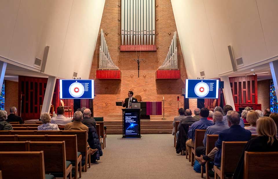lecture being held inside a chapel on campus