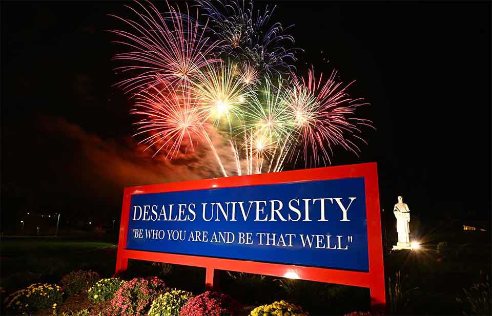 DeSales sign with fireworks