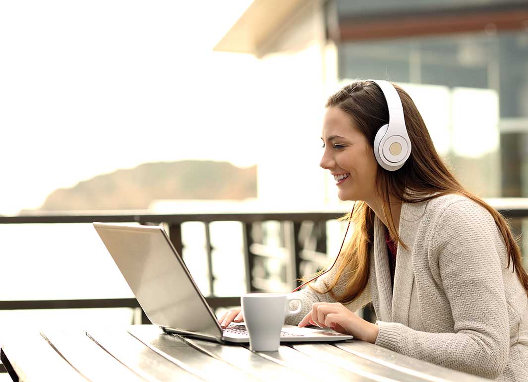 student taking class on laptop outdoors