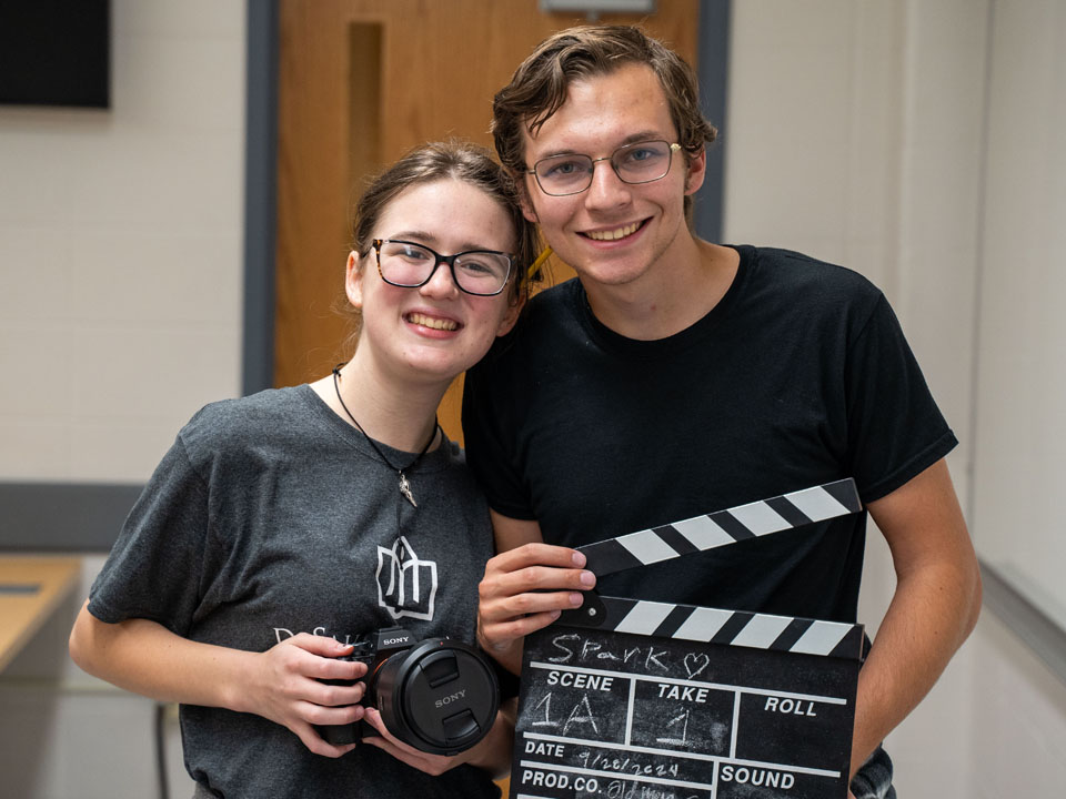 student with a camera