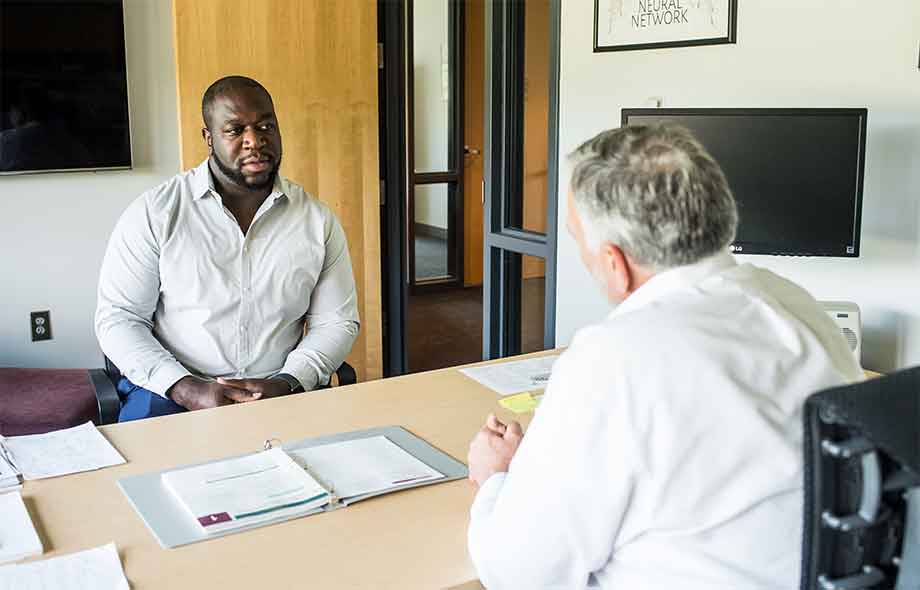 business students with admissions counselor