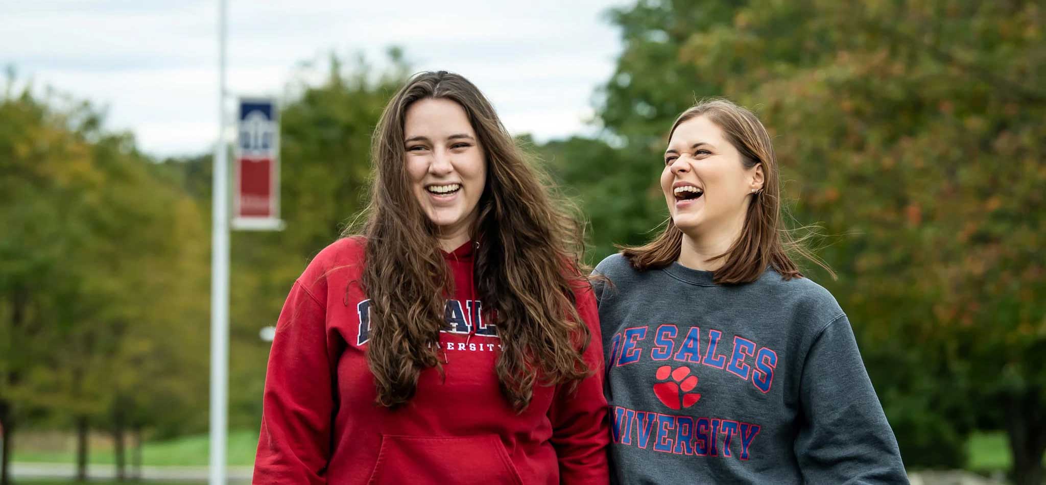 Two DeSales University students laughing and smiling