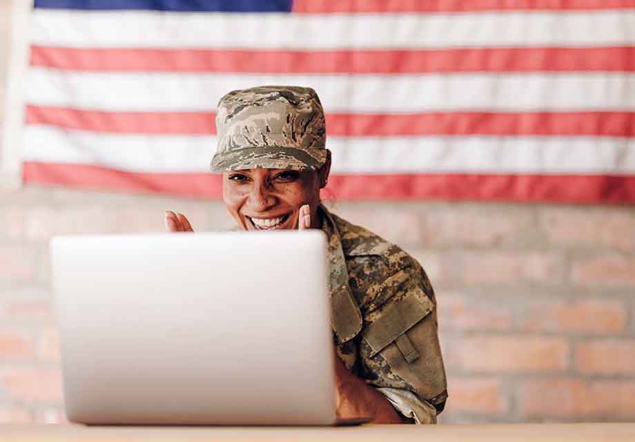 female military member at a computer