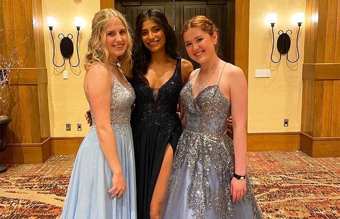 Lucy Specht, Nidhi Kumar, Paige Thompson posing for a photo at prom at Bear Creek