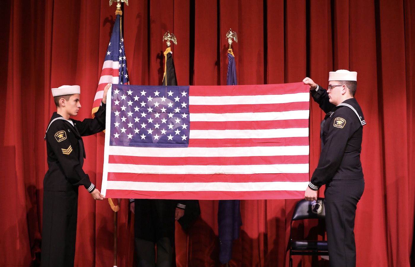 Cadets holding an American flag at Veterans Day ceremony