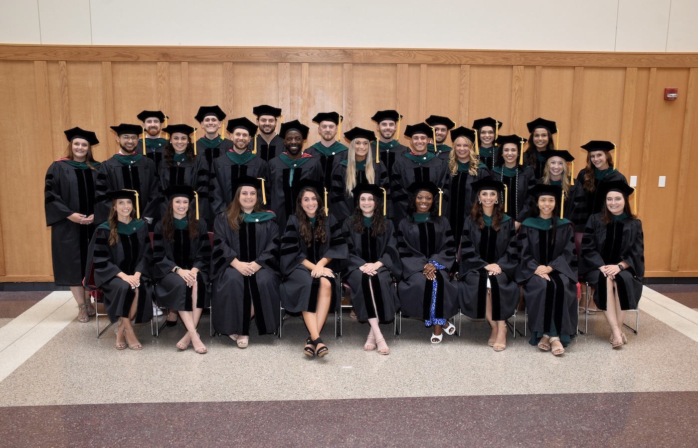 Doctor of physical therapy graduates posing together as a class at their completion ceremony