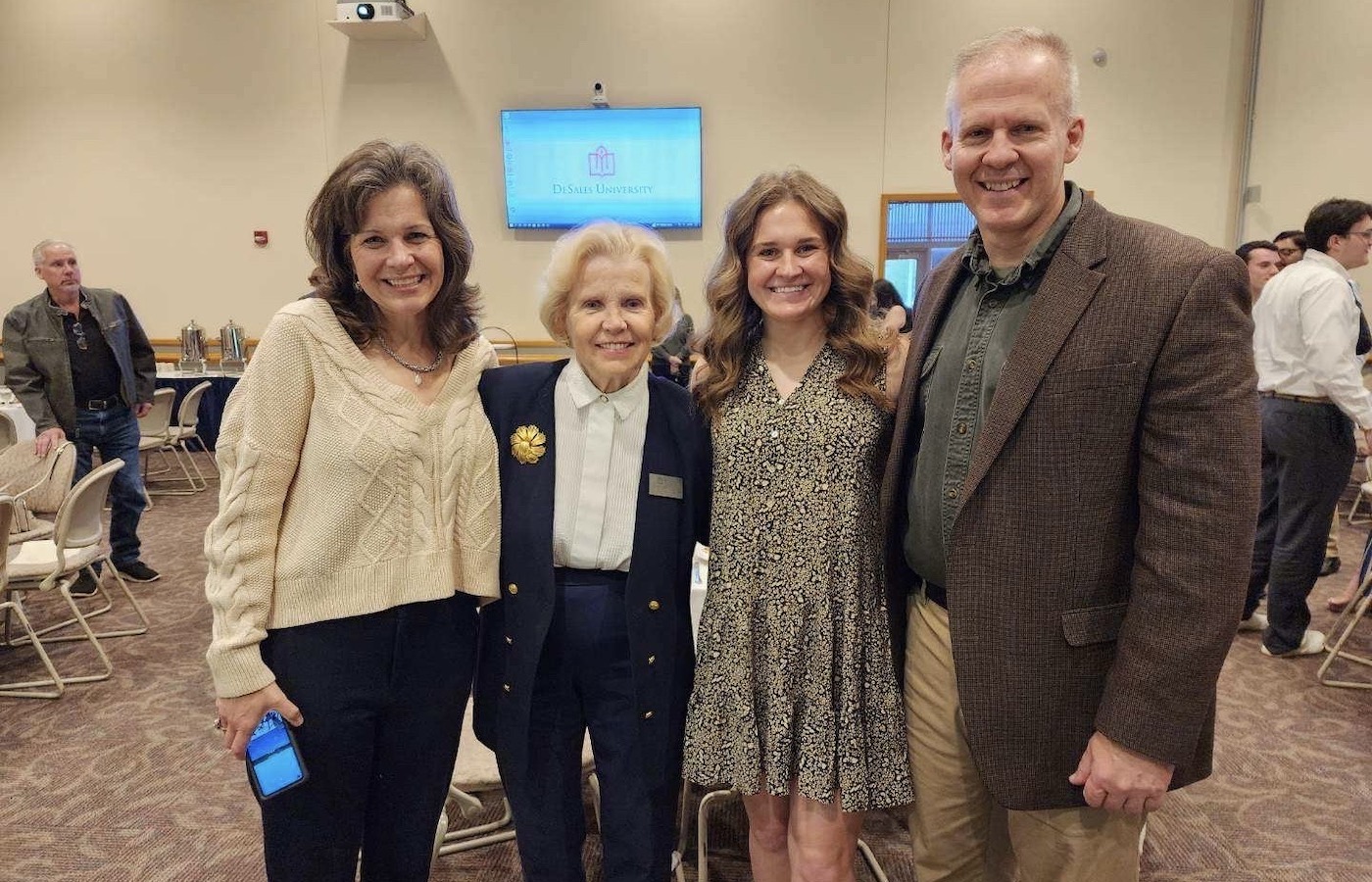 Mary Bushner posing with her parents and Karen Walton