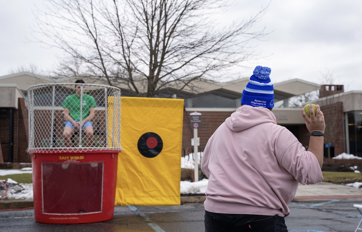 Student throwing a ball at the dunk tank
