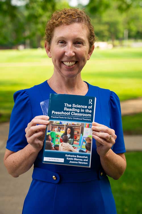 dr katrin blamey holding her newly published book