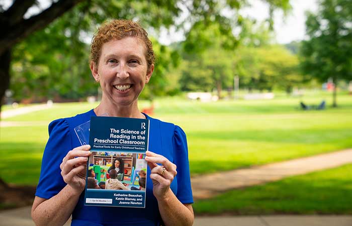 Dr Katrin Blamey holding her newly published book