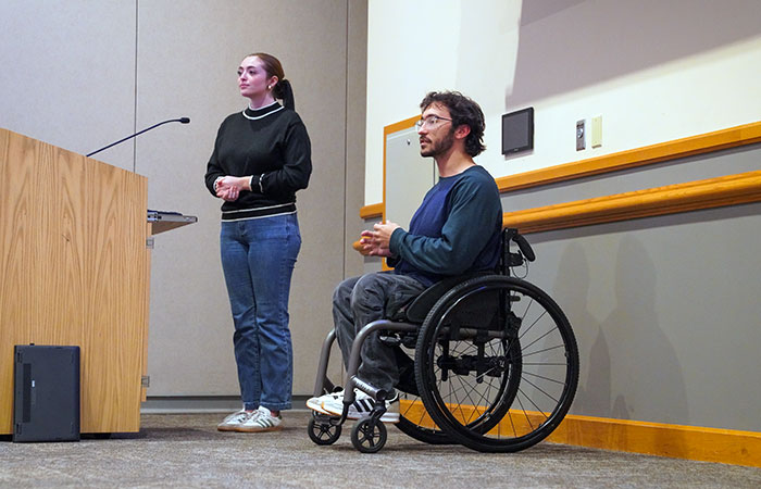 adam perone and janae toper giving a presentation