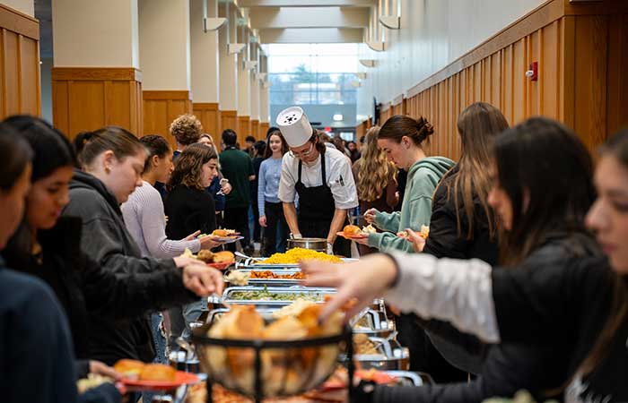 students getting food from a buffet line