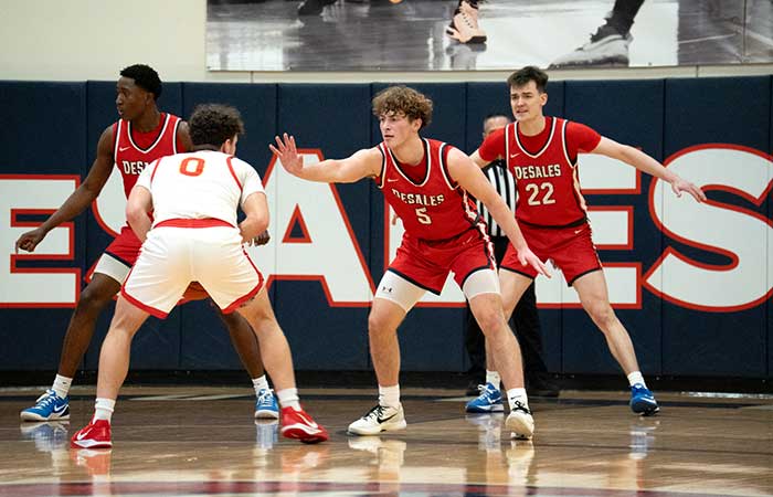 the DeSales men's basketball team defending against a shot