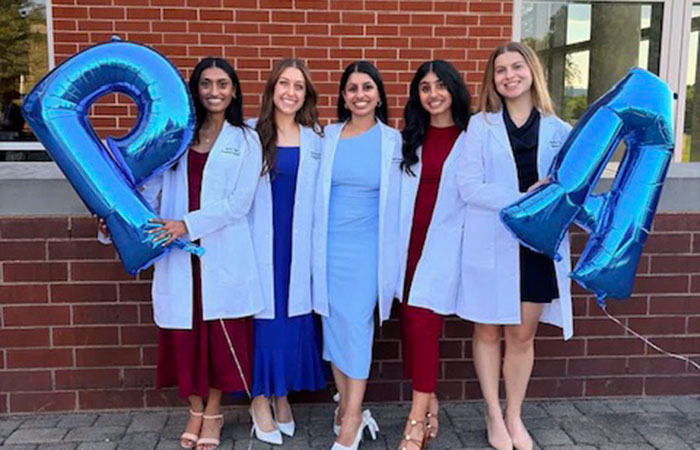 physician assistant students standing with P and A balloons